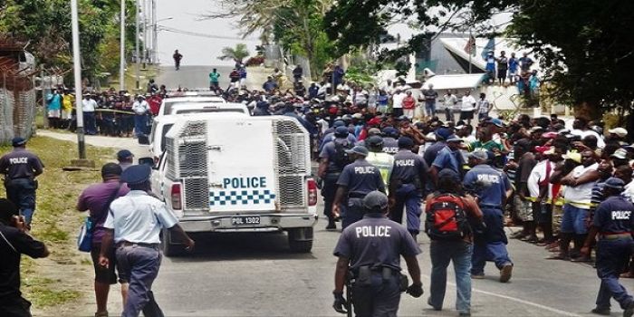 Crowds gather to witness the convicted MP&#039;s inside the escorted Police Vehicle in front of the