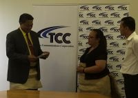 Hon. Poasi Tei Minister of Public Enterprises Received Dividents from Aloma Johanson Chairlady TCC and CEO TCC CEO Mr. Rizvi Jurangpathy