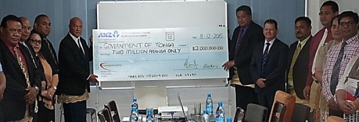 Chairman of TPL Board of Directors Carl Sanft presents a $2 million pa’anga dividend to the Minister of Public Enterprises, Hon. Poasi Tei