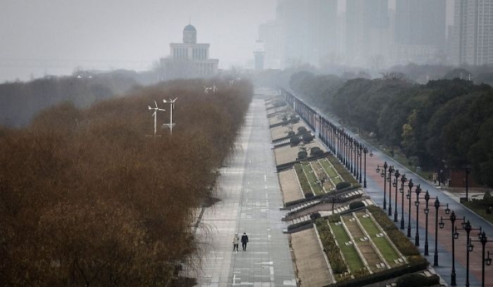 Two residents walk in an empty Jiangtan Park, in Wuhan, China, on January 27, 2020