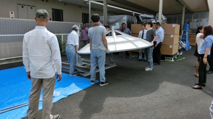 The training team assembles a Himawari reception dish as a demonstration at Oriental Electronic Inc., Kyoto, Japan