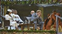 Prince Harry drinks kava as his wife Meghan, the Duchess of Sussex, looks on at a traditional welcome ceremony after they arrived in Suva, Fiji